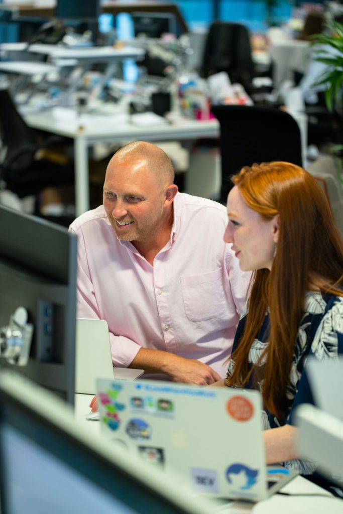 Employees discussing over a computer